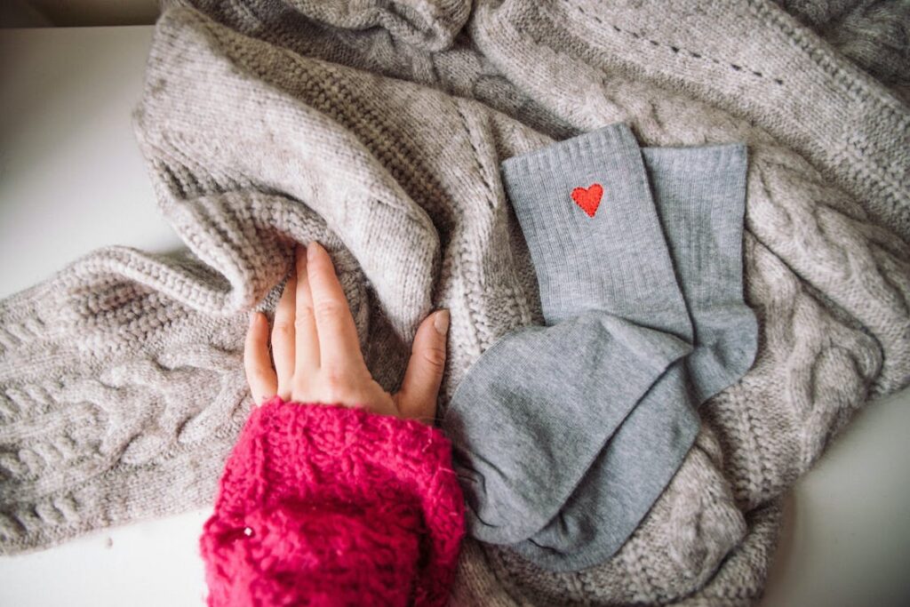 person preparing sweaters when learning how to wash wool at home